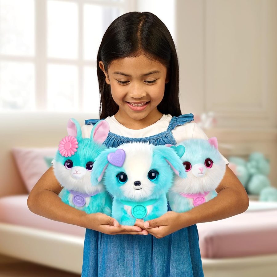 A girl holding three blue and pink ScruffaLuvs Surprise Pets